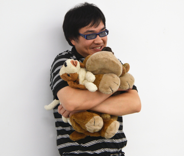 Man Hugging Stuffed Animals
